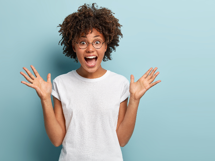 A girl gaping at the screen with happiness