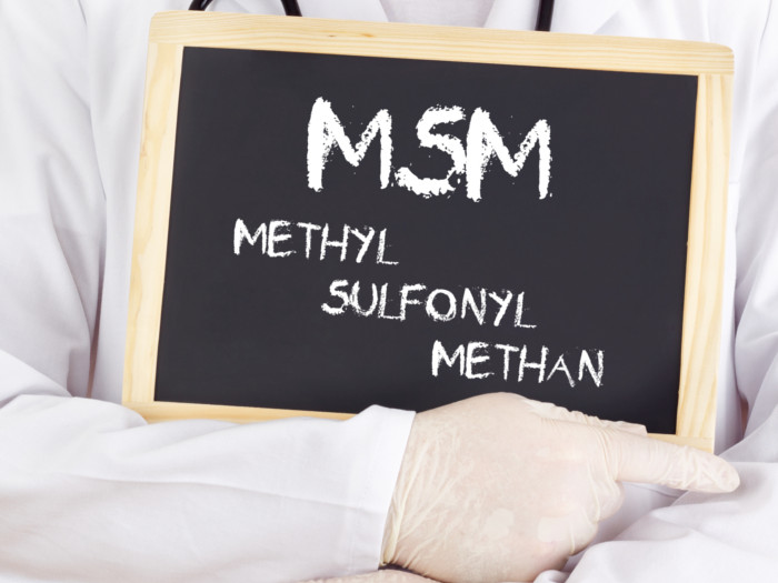 A person holding a board with full scientific name for MSM