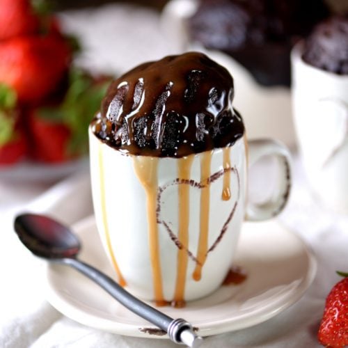 Delicious chocolate cake cooked in a microwave in a mug with caramel syrup