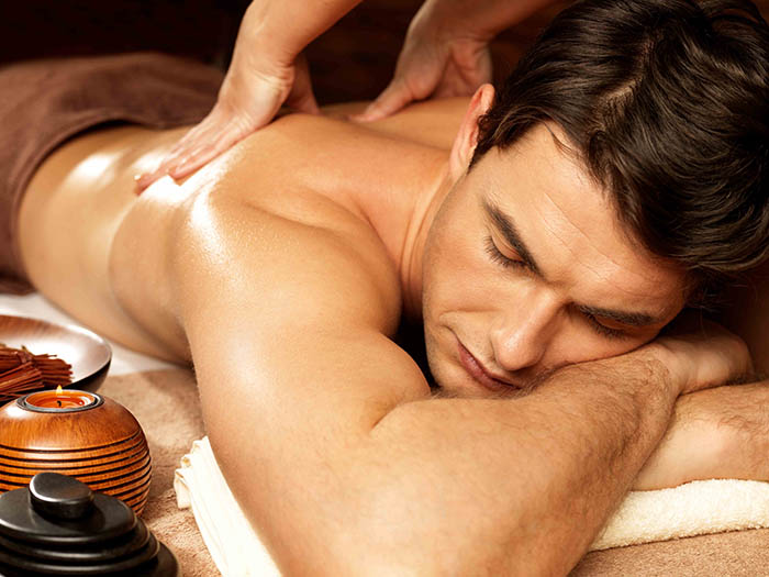 A man getting a relaxing back massage at a spa