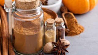 A close-up shot of different spices and their respective powders