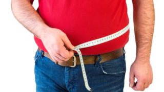 A man measuring his waist