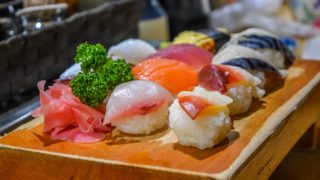 Raw rice rolls on a wooden platter