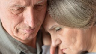 Close-up portrait of a sad elderly couple