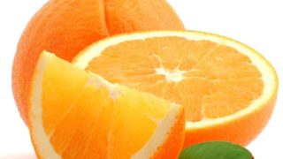 Whole orange with orange slices against a white background