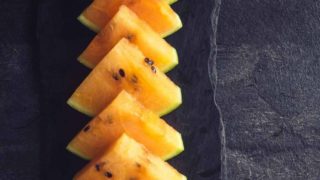 Slices of orange-watermelon placed on a tray.