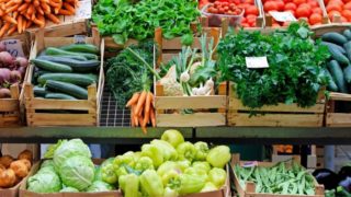 Many boxes full of organic produce at a farmers' market