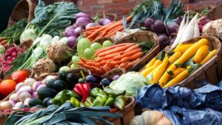 Display of shelves of vegetables at a grocer.
