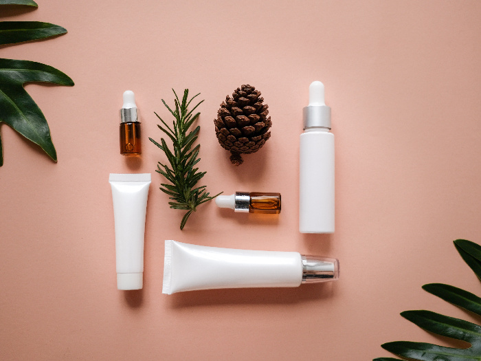 vegan beauty products arranged on a pink background