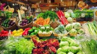 A close-up shot of the vegetable aisle in a supermarket