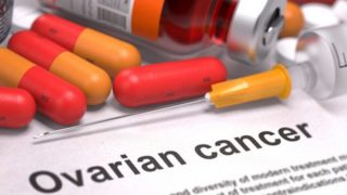 Printed diagnosis on a white background with a text "Ovarian Cancer" and pills, syringe, and medicine bottle