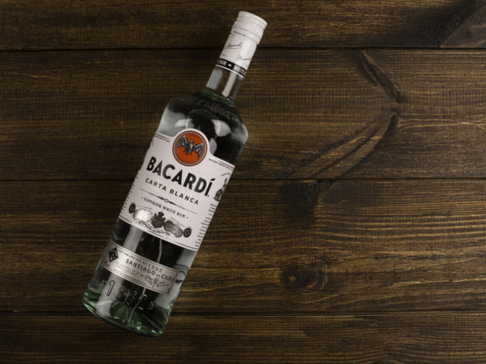 A top view of a Bacardi rum bottle on a wooden counter