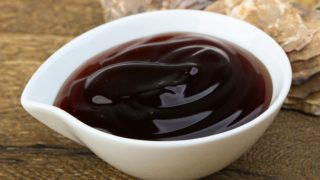 A white-colored bowl filled with oyster sauce