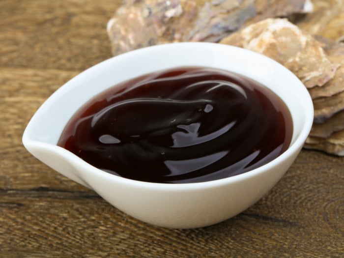 A white-colored bowl filled with oyster sauce