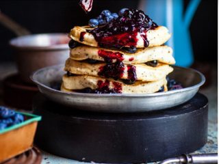 Vegan protein pancake covered in maple syrup and mixed berries