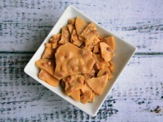 peanutbrittletwo Homemade microwave peanut brittle pieces in a white dish