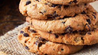 Peanut butter chocolate chip cookies stacked on one another