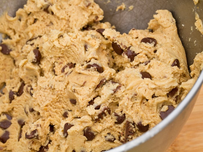 Peanut butter chocolate chip cookie dough in a steel bowl