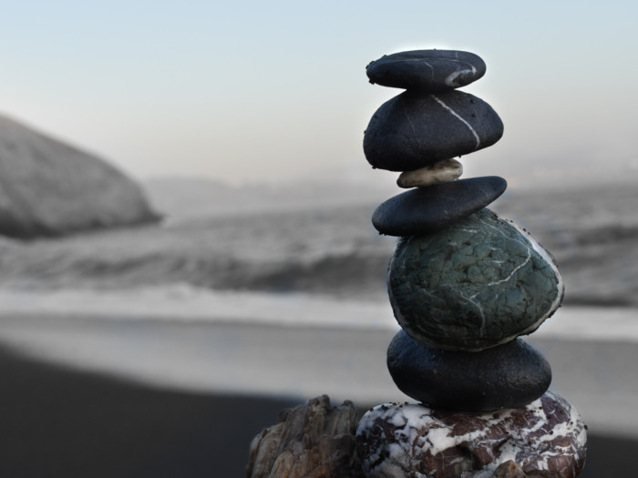 A close-up shot of pebbles stacked on a beach