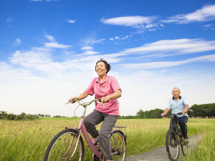Two people cycling on a farm