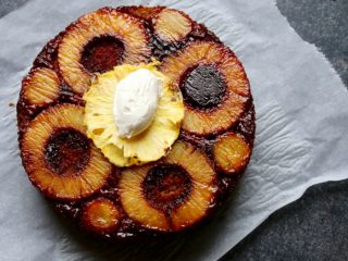 pineappleupsidedowncaketwo A flat-lay shot of pineapple upside down cake on a white napkin