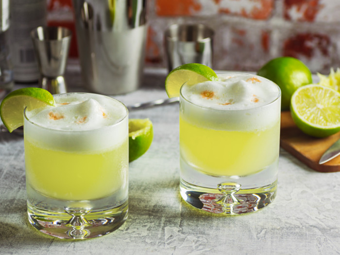 pisco sour cocktails in glasses on a counter