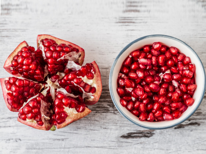 Freshly cleaned pomegranate seeds in a bowl