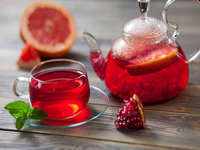 Pomegranate tea in a cup and kettle