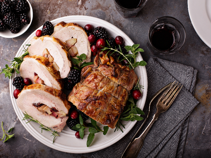 Roasted pork loin stuffed with apple and cranberry with spices