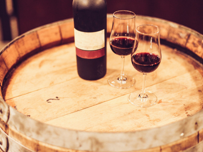 Port wine glasses besides a bottle