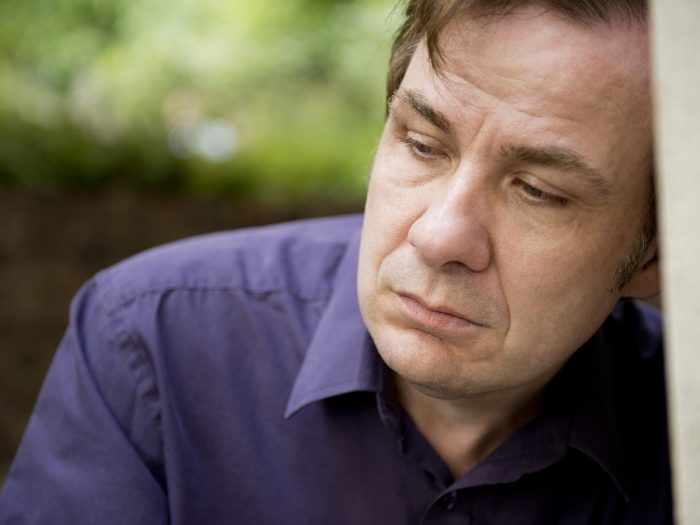 An old man in a pensive mood in the garden