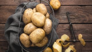 A couple of potatoes in a metal basket
