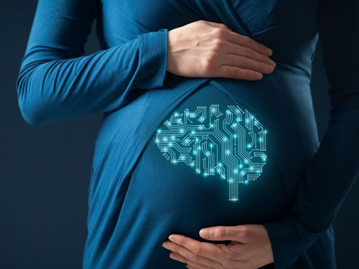 A holographic image of a brain on a pregnant woman's stomach