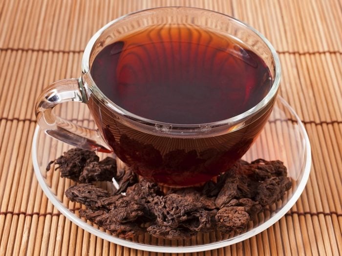 A cup of Puerh tea kept on a wooden surface