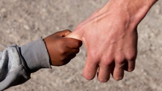 Pic of a child's hand holding an adult's