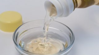 Rice vinegar poured into an ingredient bowl