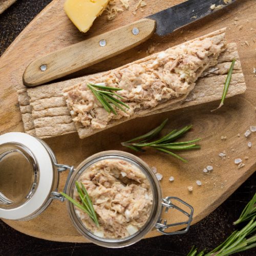 Tuna pate with egg, cheese in a jar and crispy bread.