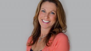 Robin Miller smiling and posing for a photograph