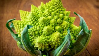 Romanesco broccoli, or Roman cauliflower on wooden table