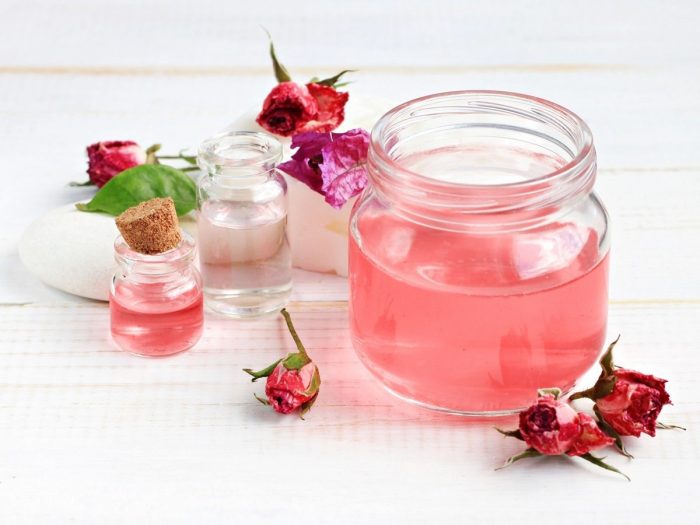 Large bottle of rose water with two smaller bottles