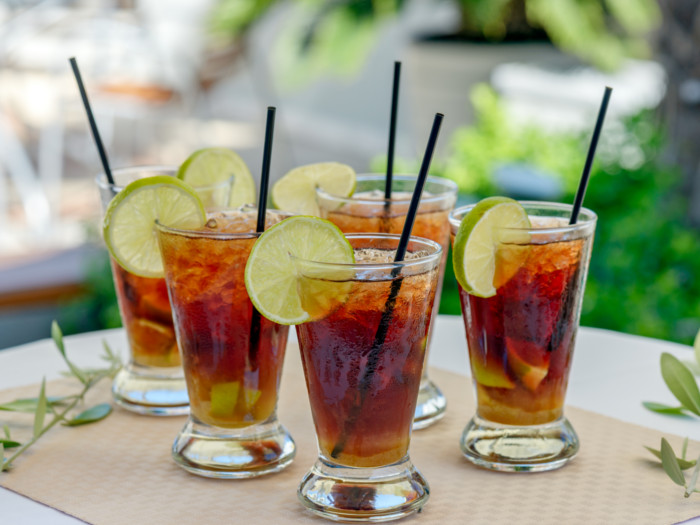 Fresh rum mocktails on a cream placemat with blurred background