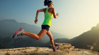 A woman in workout clothes running outdoors