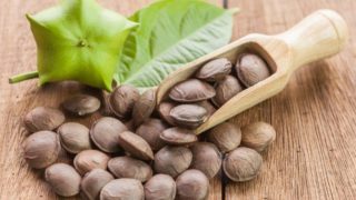 A couple of sacha inchi seeds on a wooden platform