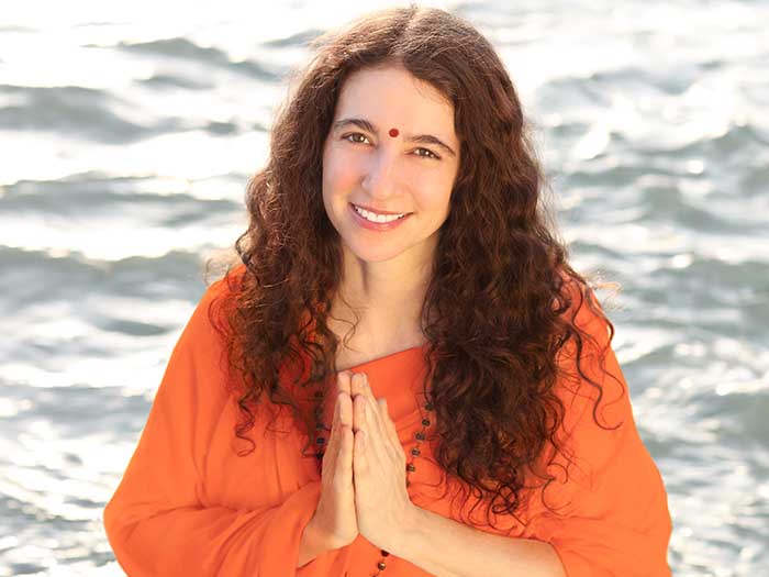 Sadhvi Bhagawati Saraswatiji folding her hands and smiling at the camera