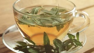A cup of tea infused with sage leaves
