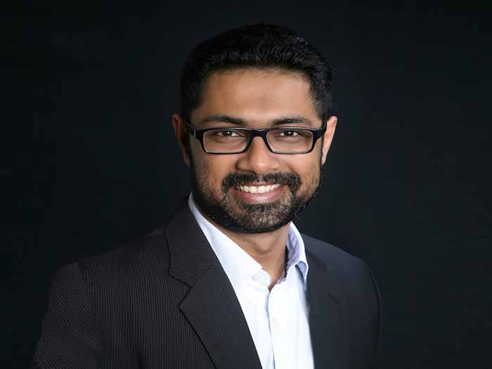 A headshot of Sanket Prabhu smiling