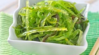 Bowl of sea kale on a green mat