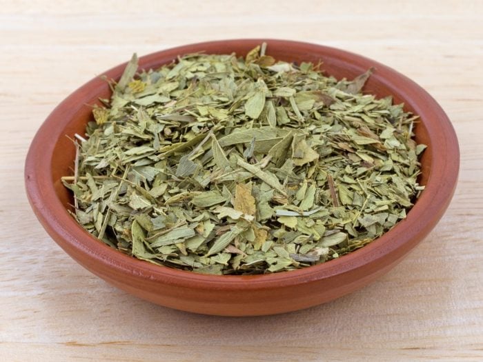 A bowl of dried senna leaves which is used to make senna tea