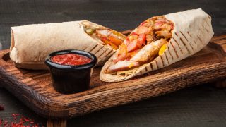 A cut kebab, shawarma, with grilled meal and vegetables