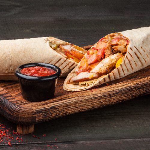 A cut kebab, shawarma, with grilled meal and vegetables A cut kebab, shawarma, with grilled meal and vegetables